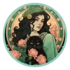A Virgo woman sits in front of flowers while a black cat lays on her dress